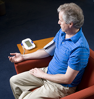 Man taking blood pressure at home.